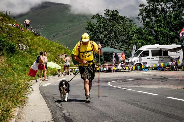 A spectator and his dog walk up the Col de Peyresourde - Tour de France 2017
